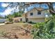 Inviting front exterior with mature trees and landscaped yard, showcasing the home's curb appeal at 114 Windy Pl, Brandon, FL 33511