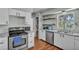 Functional kitchen with stainless steel appliances, pantry, and double sink, providing convenience and style at 114 Windy Pl, Brandon, FL 33511