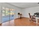 Bright living room featuring wood floors and sliding glass doors to the screened patio at 114 Windy Pl, Brandon, FL 33511