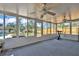Sunroom offers ample natural light and features an exercise bike and ceiling fans at 114 Windy Pl, Brandon, FL 33511