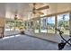 Bright sunroom with lots of windows, ceiling fans, and tile flooring overlooking backyard at 114 Windy Pl, Brandon, FL 33511