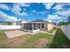 Expansive backyard with a screened patio, brick terrace, and white privacy fence at 3425 San Moise Pl, Plant City, FL 33567