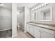 Bright bathroom featuring double sinks with granite countertops, and dual mirrors at 3425 San Moise Pl, Plant City, FL 33567