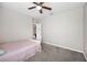 Bedroom with plush carpeting, a ceiling fan, and easy access to other rooms at 3425 San Moise Pl, Plant City, FL 33567