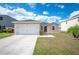 This home features a two-car garage, landscaped yard, and neutral exterior paint at 3425 San Moise Pl, Plant City, FL 33567