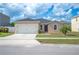Charming single-story home features a two-car garage, landscaped yard, and neutral exterior paint at 3425 San Moise Pl, Plant City, FL 33567