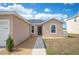 Inviting single-story home with a well-maintained lawn and neutral-toned exterior, under a bright sky at 3425 San Moise Pl, Plant City, FL 33567