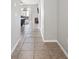 Hallway with tiled floors leading into the living room with lots of natural light at 3425 San Moise Pl, Plant City, FL 33567