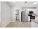 Bright kitchen features stainless steel appliances and tile flooring with an adjacent laundry room at 3425 San Moise Pl, Plant City, FL 33567