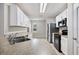 Open kitchen with stainless steel appliances, white cabinets, and neutral countertops at 3425 San Moise Pl, Plant City, FL 33567
