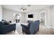 Spacious living room with tile floors, neutral walls, access to the backyard and TV at 3425 San Moise Pl, Plant City, FL 33567