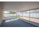 Relaxing screened patio with a carpeted floor and a view of the fenced backyard and blue skies at 3425 San Moise Pl, Plant City, FL 33567