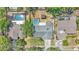 Aerial view of a backyard pool and gazebo, and the house nestled in a lovely, lush neighborhood at 619 Shady Nook Dr, Brandon, FL 33511