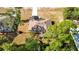 Aerial view of the home, showcasing roof, driveway, landscaping, and its location among mature trees at 12043 Centralia Rd, Weeki Wachee, FL 34614