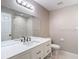 A bright bathroom with a new vanity, a large mirror, and a tub/shower combination with bright white tile at 12043 Centralia Rd, Weeki Wachee, FL 34614