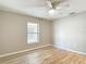 Bright bedroom with neutral walls, wood-look floors, ceiling fan and a window view at 12043 Centralia Rd, Weeki Wachee, FL 34614
