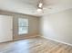 Bright bedroom with neutral walls, wood-look floors, ceiling fan and a window view at 12043 Centralia Rd, Weeki Wachee, FL 34614