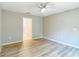 Bedroom features neutral paint, ceiling fan, and luxury vinyl plank flooring at 12043 Centralia Rd, Weeki Wachee, FL 34614