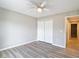 Neutral bedroom with wood floors, a ceiling fan, and a closet with bi-fold doors at 12043 Centralia Rd, Weeki Wachee, FL 34614