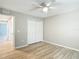 Bedroom with wood-look floors, ceiling fan, closet and white trim at 12043 Centralia Rd, Weeki Wachee, FL 34614