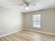 Bright bedroom with neutral walls, wood-look floors, ceiling fan and a window view at 12043 Centralia Rd, Weeki Wachee, FL 34614