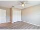 A neutral bedroom features wood-look floors, a ceiling fan, and a closet at 12043 Centralia Rd, Weeki Wachee, FL 34614