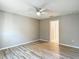 Bright bedroom featuring neutral paint, ceiling fan, and luxury vinyl plank flooring at 12043 Centralia Rd, Weeki Wachee, FL 34614