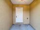 Close up of the front door with a neutral color and a textured exterior wall at 12043 Centralia Rd, Weeki Wachee, FL 34614