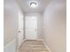 Hallway with wood floors, neutral paint, and white doors at 12043 Centralia Rd, Weeki Wachee, FL 34614