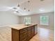 Spacious open concept kitchen features an island with sink and stainless steel dishwasher at 12043 Centralia Rd, Weeki Wachee, FL 34614