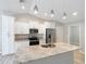 Modern kitchen features white cabinets, stainless appliances, and an island with granite countertops at 12043 Centralia Rd, Weeki Wachee, FL 34614