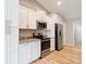 Modern kitchen with white cabinetry, stainless steel appliances, and granite countertops at 12043 Centralia Rd, Weeki Wachee, FL 34614