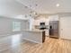 Modern kitchen with white cabinetry, stainless steel appliances, granite countertops, and an island at 12043 Centralia Rd, Weeki Wachee, FL 34614