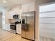 Well-equipped kitchen with stainless steel appliances and an adjacent pantry for ample storage at 12043 Centralia Rd, Weeki Wachee, FL 34614
