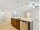 Bright kitchen features a large island with granite countertops and stainless steel dishwasher at 12043 Centralia Rd, Weeki Wachee, FL 34614