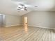 Bright living room boasting wood-look floors, a ceiling fan, and plenty of natural light at 12043 Centralia Rd, Weeki Wachee, FL 34614