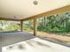 Covered back patio with concrete flooring that overlooks the home's backyard at 12043 Centralia Rd, Weeki Wachee, FL 34614