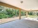 Home's covered back patio provides an outdoor seating and relaxing space with a view of the yard at 12043 Centralia Rd, Weeki Wachee, FL 34614