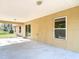 Home's covered back patio overlooking the backyard; features concrete flooring, ceiling lights, and shade at 12043 Centralia Rd, Weeki Wachee, FL 34614