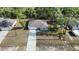 Aerial view of a single-story home, showcasing its location and neighborhood in a wooded area at 12053 Centralia Rd, Weeki Wachee, FL 34614