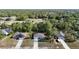 Aerial view showing a single-story home in a community with neighboring houses and a lush, green landscape at 12053 Centralia Rd, Weeki Wachee, FL 34614