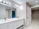 Bathroom featuring a double sink vanity with modern fixtures, ample counter space, and neutral wall color at 12053 Centralia Rd, Weeki Wachee, FL 34614