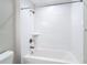 Bathroom featuring a white tiled shower-tub combination and bronze fixtures at 12053 Centralia Rd, Weeki Wachee, FL 34614