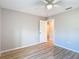 Neutral bedroom features wood-look floors and a white door leading to another room at 12053 Centralia Rd, Weeki Wachee, FL 34614