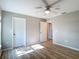 Bedroom with wood-look floors, neutral walls, two doors and a ceiling fan at 12053 Centralia Rd, Weeki Wachee, FL 34614