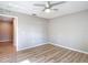 Bedroom with wood-look floors, neutral walls, and doorway to another room at 12053 Centralia Rd, Weeki Wachee, FL 34614