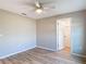 Neutral bedroom features wood-look floors and a white door leading to a closet at 12053 Centralia Rd, Weeki Wachee, FL 34614