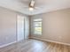 Bedroom with natural light, door, and wood look flooring at 12053 Centralia Rd, Weeki Wachee, FL 34614