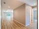 Hallway leading to the living room featuring light wood flooring, modern lighting, and neutral paint at 12053 Centralia Rd, Weeki Wachee, FL 34614