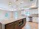 Bright kitchen with an island, granite countertops, stainless steel appliances, and modern pendant lighting at 12053 Centralia Rd, Weeki Wachee, FL 34614